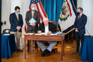 Gov. Justice ceremonially signs intermediate appeals court bill